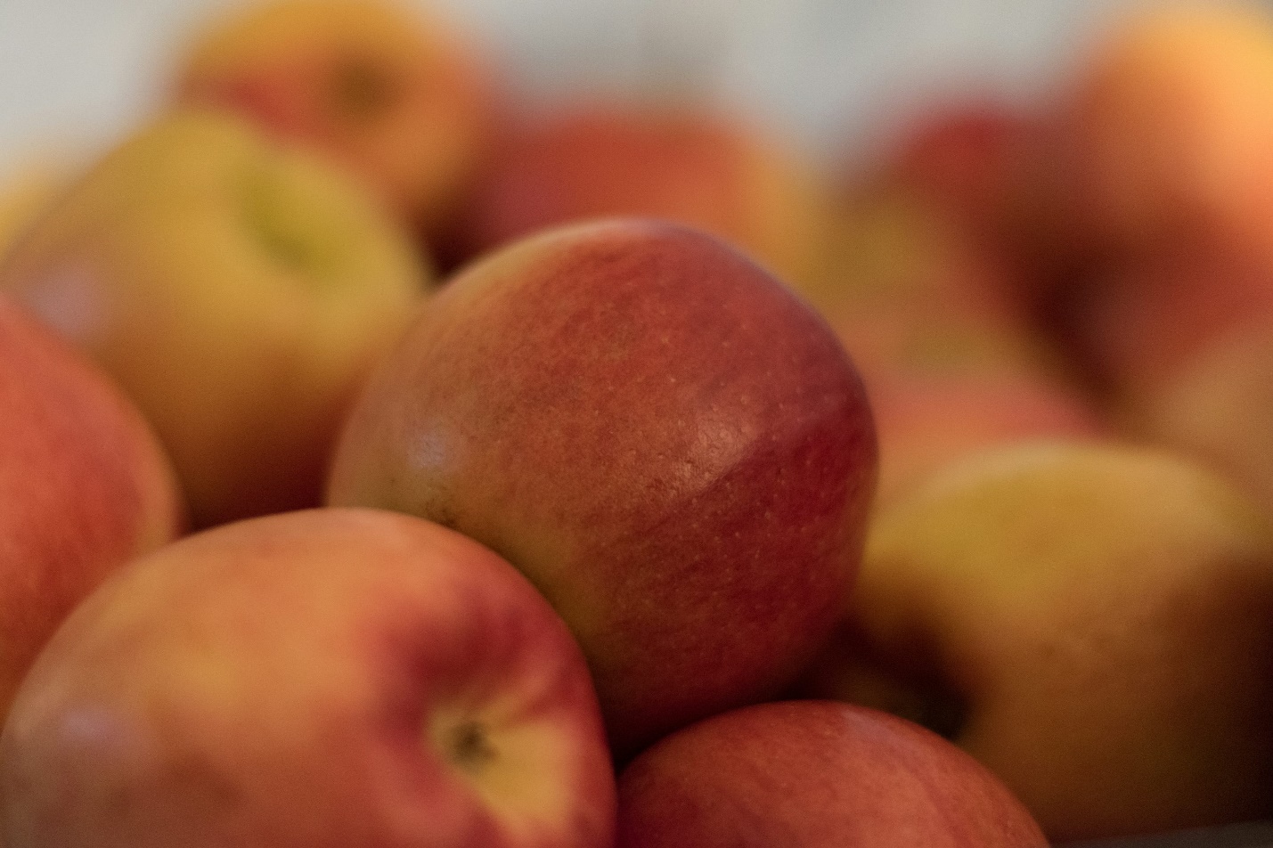 a pile of apples sitting on top of a table