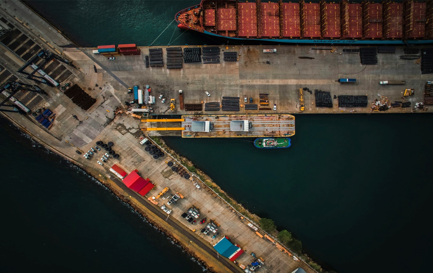 An aerial view of a cargo ship docked at a dock